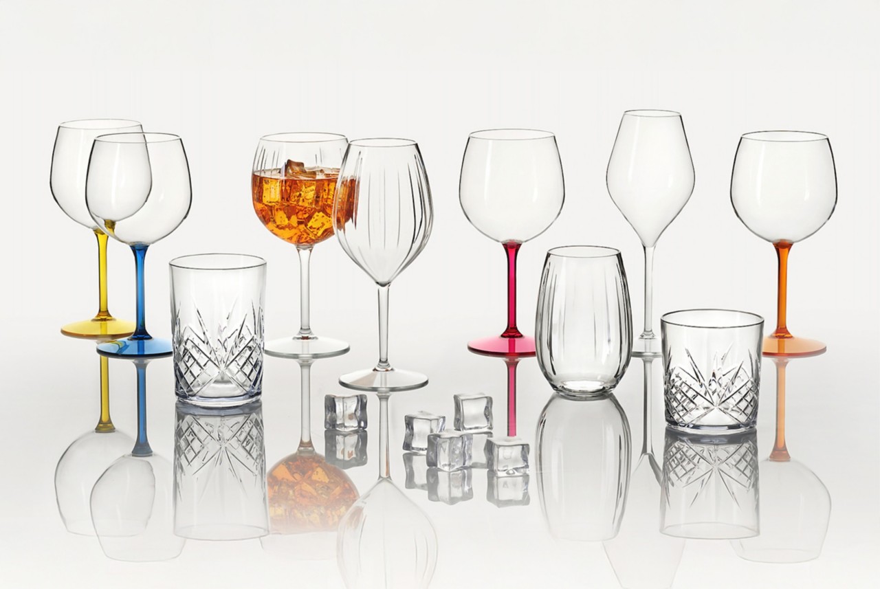 Clear wine glasses with different colored stems and wine cups made of Tritan Renew copolyester. Clear wine glasses with different colored stems and wine cups made of Tritan Renew copolyester.