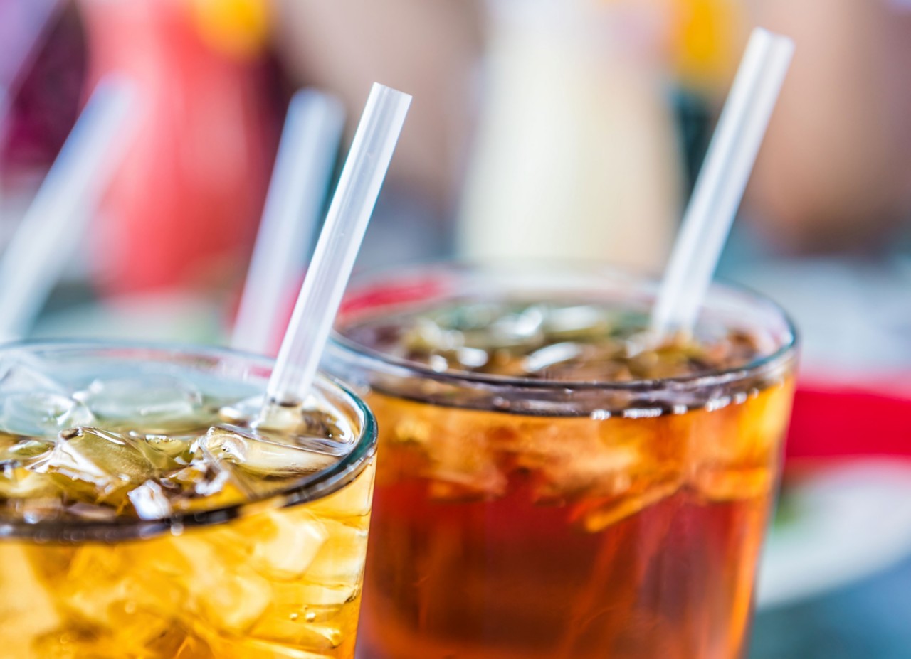 Straws sit in clear glasses filled with ice and a drink  Straws sit in clear glasses filled with ice and a drink